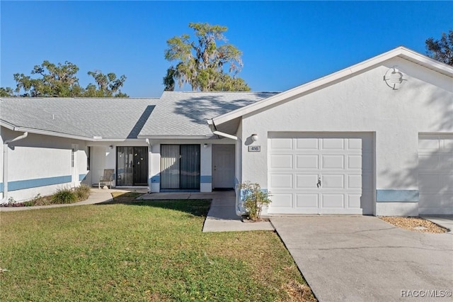 single story home with a garage and a front lawn