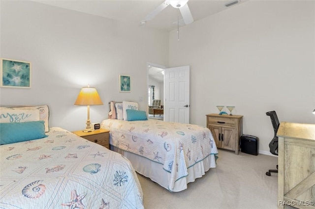 bedroom with ceiling fan, visible vents, and light colored carpet