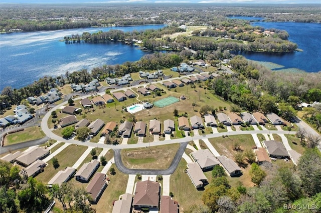 birds eye view of property with a water view and a residential view