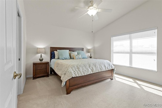 bedroom featuring ceiling fan, vaulted ceiling, and light colored carpet