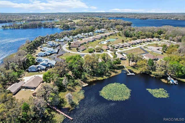 drone / aerial view with a water view and a residential view