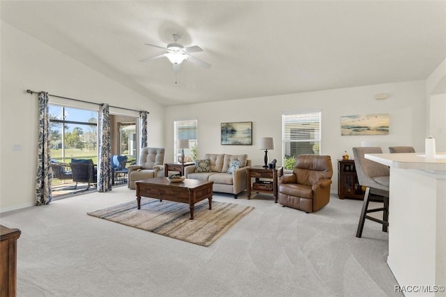 living area with lofted ceiling, light carpet, and plenty of natural light