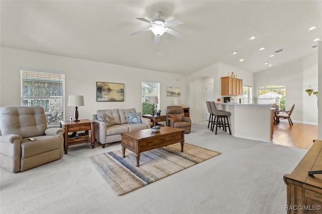 living area with a healthy amount of sunlight, recessed lighting, a ceiling fan, and light colored carpet