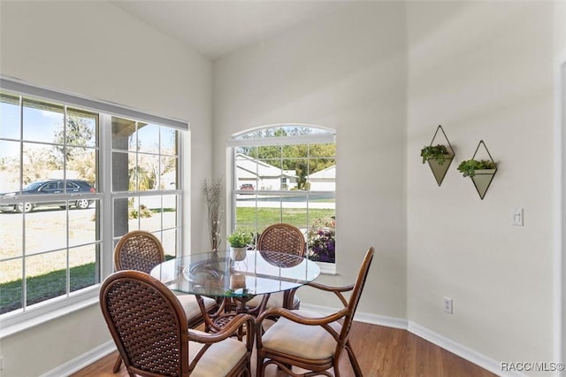 dining space featuring wood finished floors and baseboards