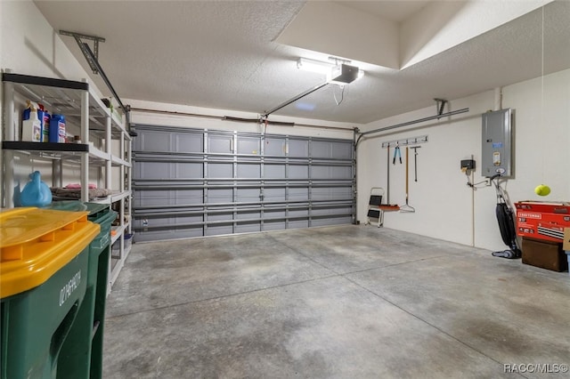 garage with electric panel and a garage door opener