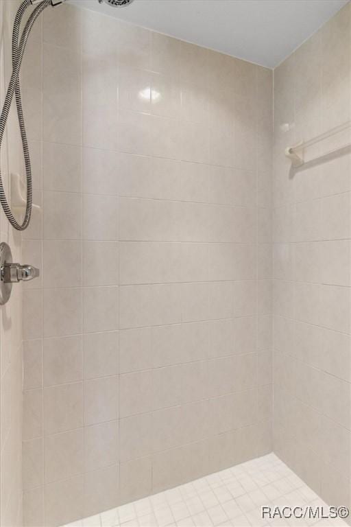 full bath featuring a tile shower