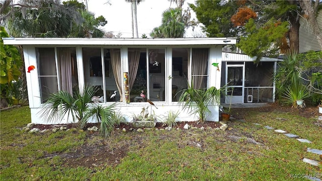 rear view of property with a sunroom