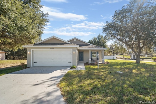 ranch-style home featuring a front lawn and a garage