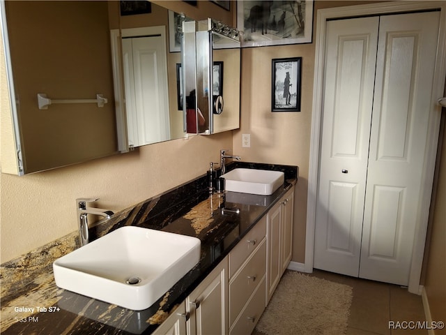 bathroom featuring tile patterned flooring and vanity