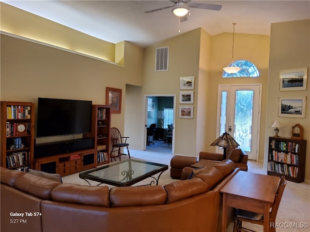 living room featuring ceiling fan, light carpet, and high vaulted ceiling