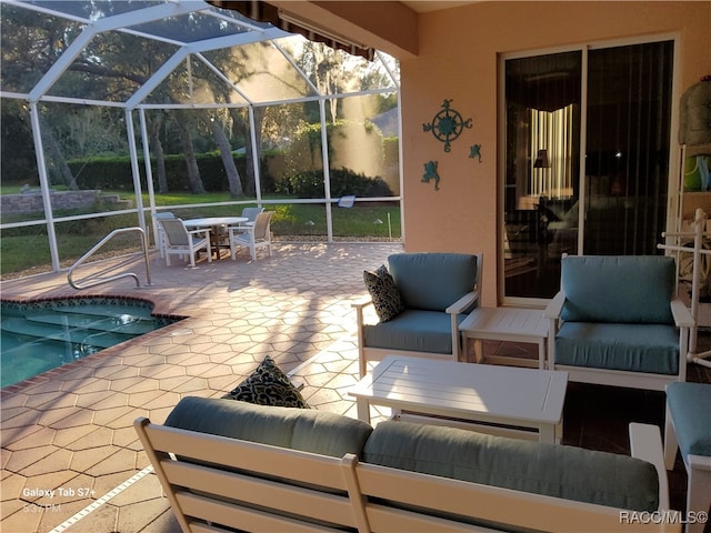 view of patio / terrace with an outdoor hangout area and glass enclosure