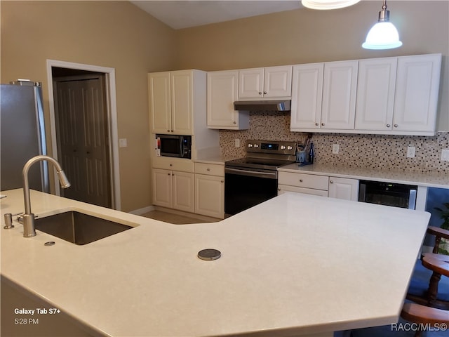 kitchen featuring backsplash, stainless steel appliances, sink, pendant lighting, and white cabinetry