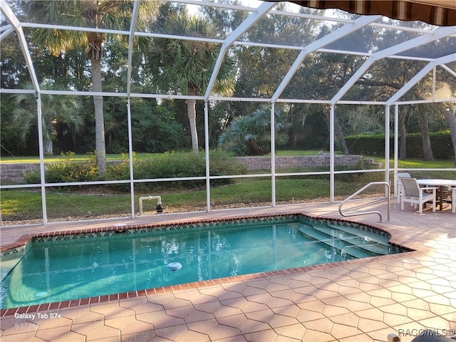 view of swimming pool with a lanai and a patio area