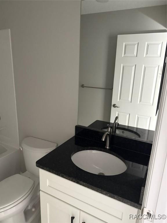 bathroom featuring toilet and vanity