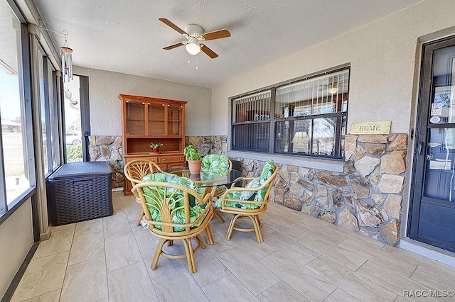 sunroom featuring ceiling fan