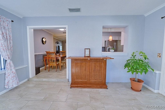 kitchen with stainless steel fridge, decorative light fixtures, and ornamental molding