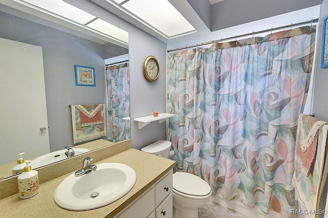 bathroom featuring vanity, curtained shower, and toilet