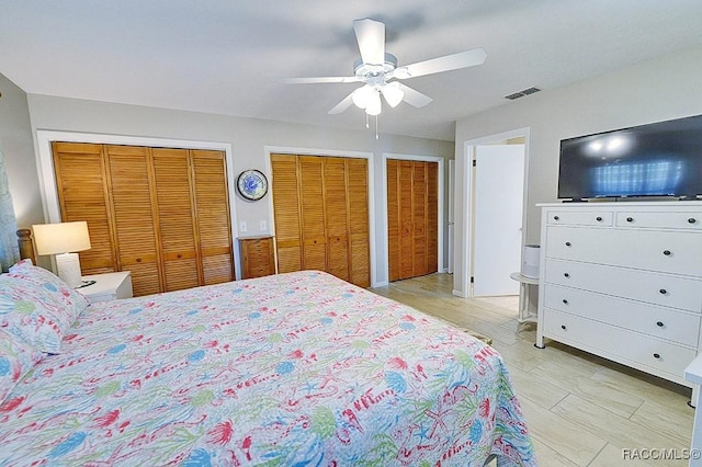 bedroom featuring ceiling fan and multiple closets