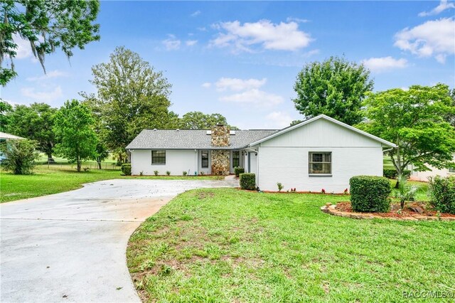 8831 E Sandpiper Dr, Inverness, FL 34450 - ranch-style house with concrete driveway, a front lawn, and a chimney