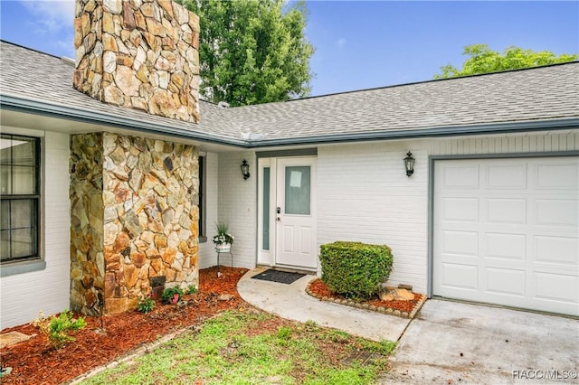 8831 E Sandpiper Dr, Inverness, FL 34450 - doorway to property featuring roof with shingles, an attached garage, brick siding, and stone siding