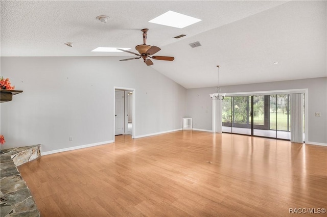 8831 E Sandpiper Dr, Inverness, FL 34450 - unfurnished living room with a skylight, light wood-type flooring, a ceiling fan, baseboards, and high vaulted ceiling