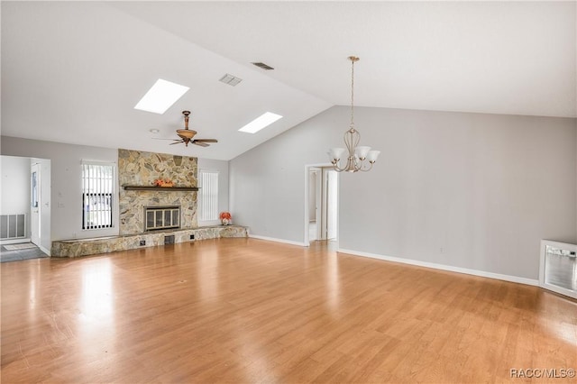 8831 E Sandpiper Dr, Inverness, FL 34450 - unfurnished living room featuring a chandelier, lofted ceiling, a skylight, light wood-style flooring, and baseboards