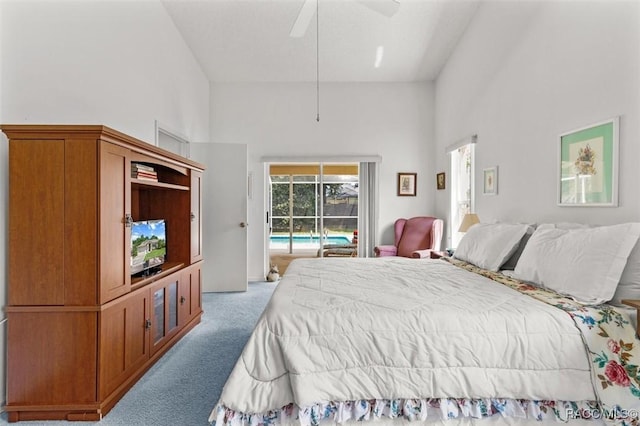 carpeted bedroom featuring ceiling fan, a high ceiling, and access to exterior