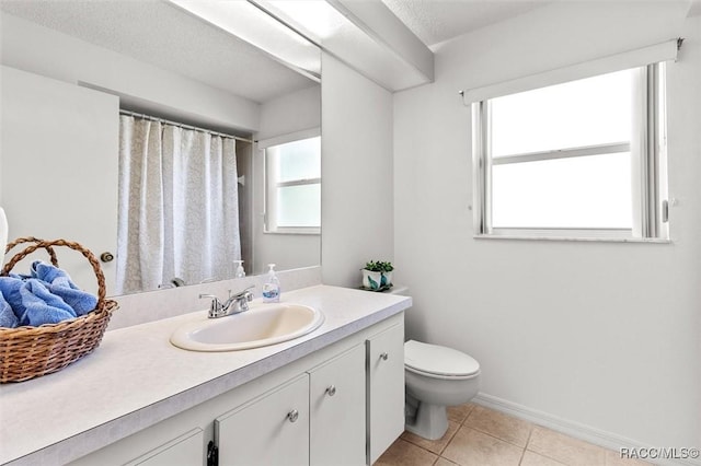 bathroom featuring vanity, toilet, and tile patterned floors