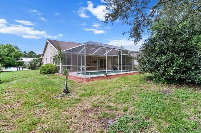 rear view of house featuring a lawn