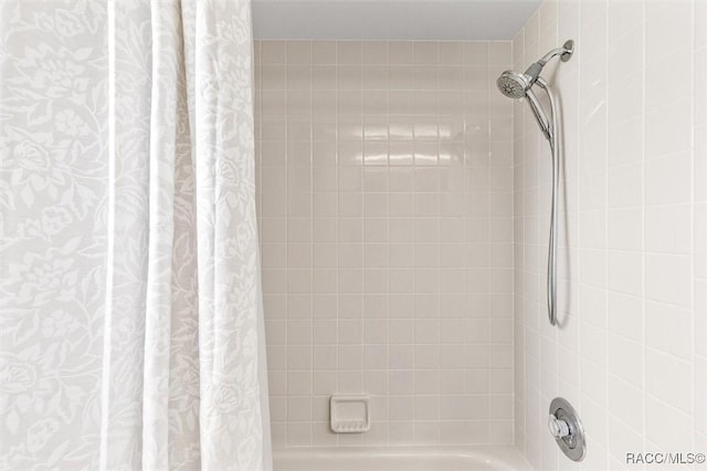 bathroom featuring shower / tub combo with curtain