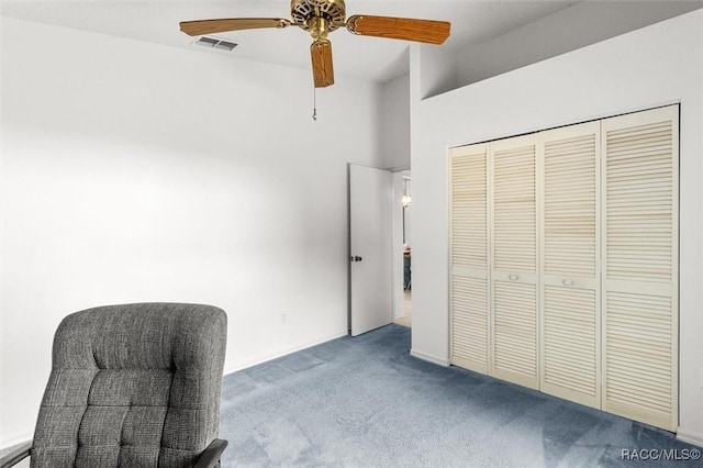 living area with ceiling fan and light colored carpet