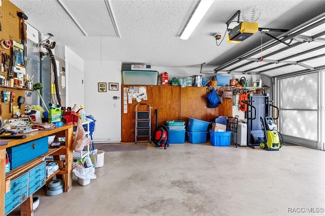 garage with a workshop area and a garage door opener