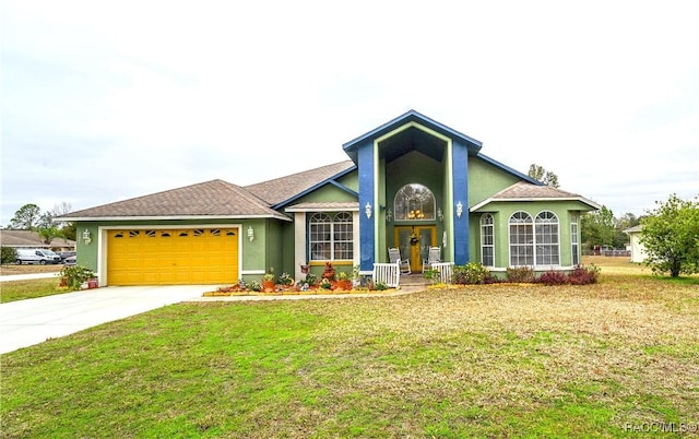 view of front of house with concrete driveway, a garage, a front yard, and stucco siding