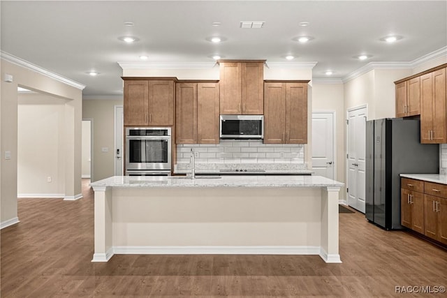 5235 N Sonora Ter, Beverly Hills, FL 34465 - kitchen with stainless steel appliances, an island with sink, tasteful backsplash, light stone counters, and crown molding
