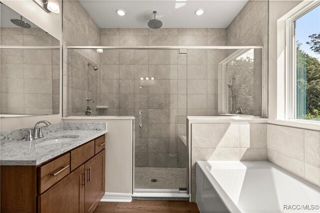 5235 N Sonora Ter, Beverly Hills, FL 34465 - bathroom featuring a shower stall, a bath, vanity, wood finished floors, and recessed lighting