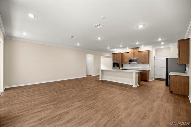 5235 N Sonora Ter, Beverly Hills, FL 34465 - kitchen with stainless steel appliances, crown molding, light countertops, open floor plan, and decorative backsplash
