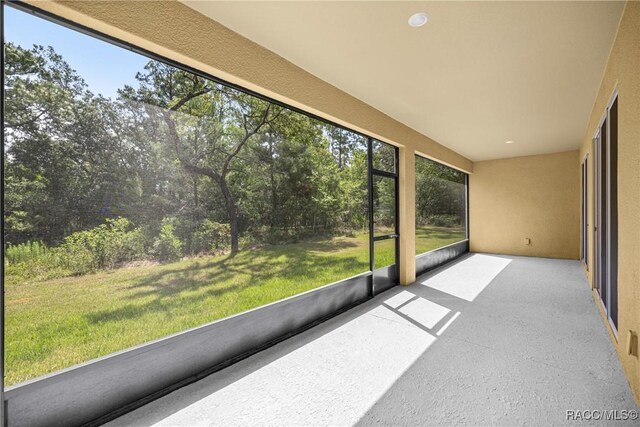 5235 N Sonora Ter, Beverly Hills, FL 34465 - unfurnished sunroom with view of wooded area