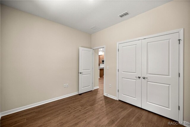 5235 N Sonora Ter, Beverly Hills, FL 34465 - unfurnished bedroom with dark wood-style flooring and a closet