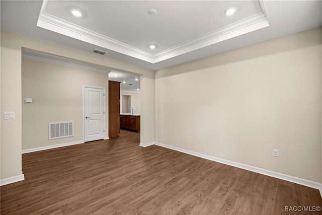 5235 N Sonora Ter, Beverly Hills, FL 34465 - spare room with crown molding, a tray ceiling, dark wood-style flooring, and recessed lighting