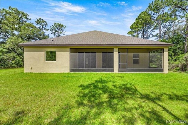 5235 N Sonora Ter, Beverly Hills, FL 34465 - back of house with a sunroom, a yard, stucco siding, and a shingled roof