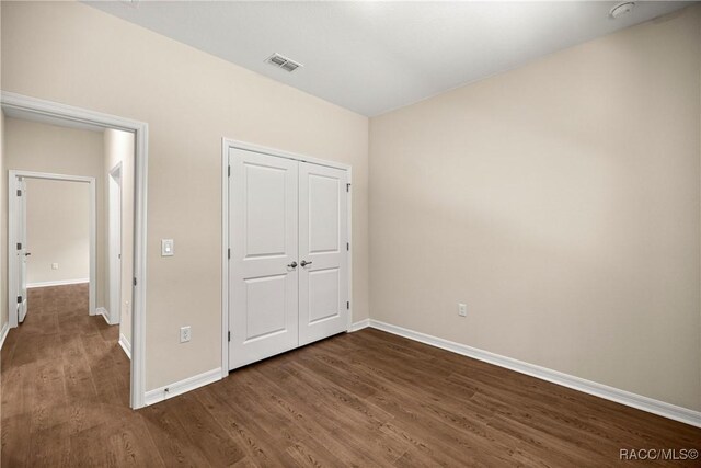 5235 N Sonora Ter, Beverly Hills, FL 34465 - unfurnished bedroom with dark wood-style flooring and a closet