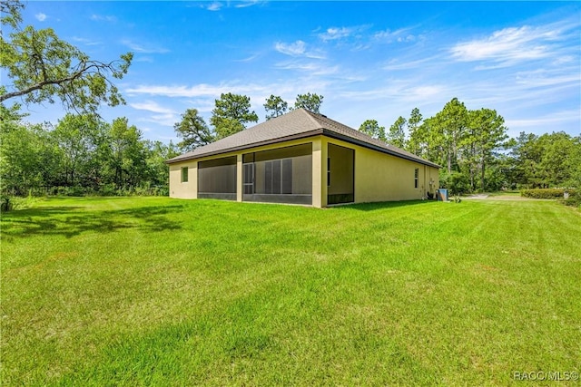 5235 N Sonora Ter, Beverly Hills, FL 34465 - back of house featuring a yard, a sunroom, and stucco siding