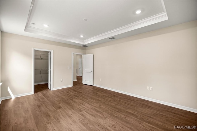 5235 N Sonora Ter, Beverly Hills, FL 34465 - unfurnished bedroom featuring a tray ceiling, ornamental molding, a spacious closet, wood finished floors, and a closet