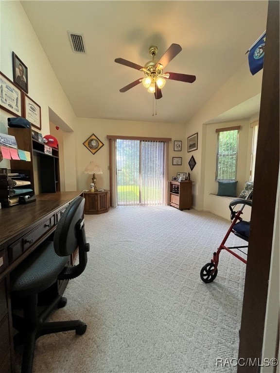 carpeted home office with plenty of natural light and ceiling fan