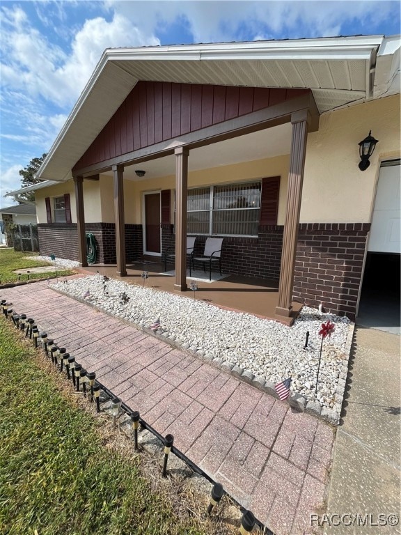 back of house featuring covered porch