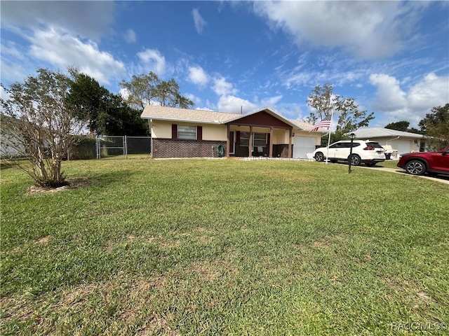 ranch-style home with a garage and a front yard