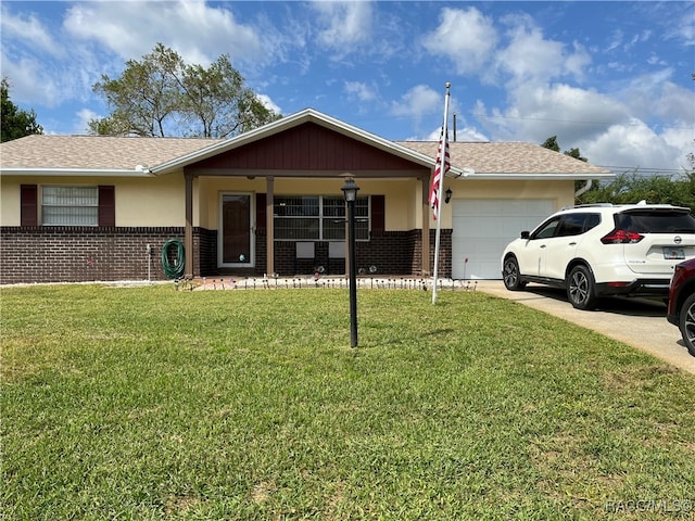 ranch-style house with covered porch, a garage, and a front lawn