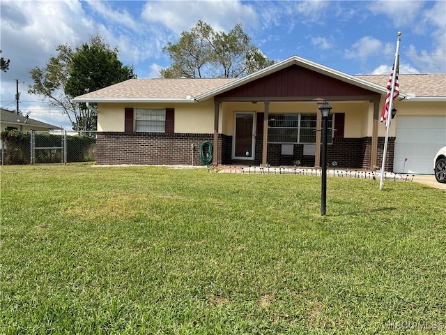 ranch-style home with a porch, a front yard, and a garage