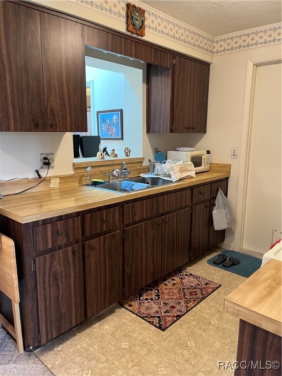 kitchen with dark brown cabinets and sink