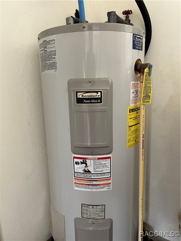 utility room featuring electric water heater